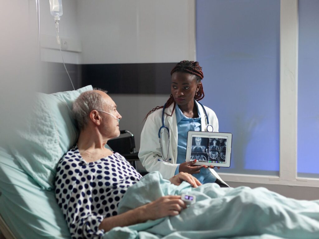 man sitting in hospital bed